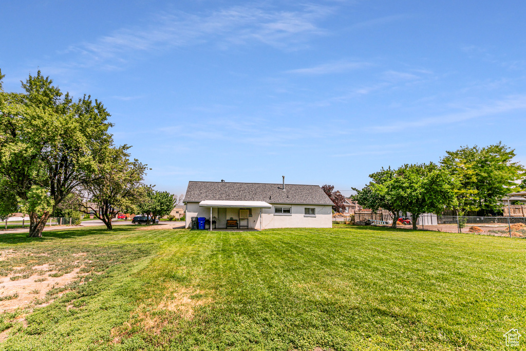 Rear view of property featuring a lawn