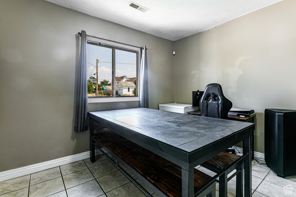 Office area featuring light tile patterned floors