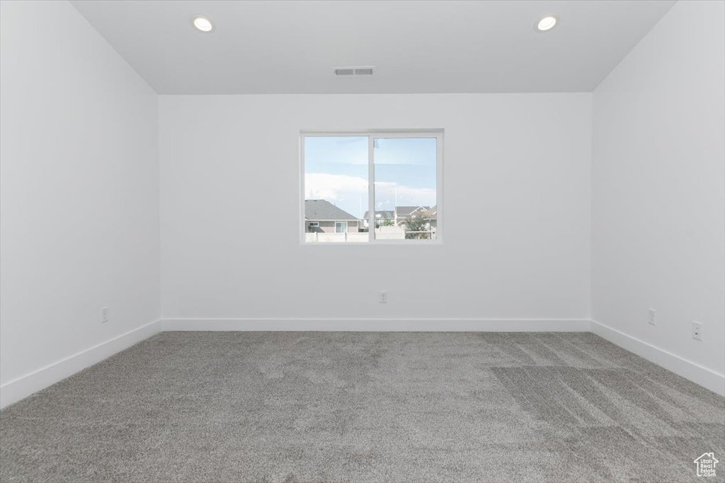 Spare room featuring light colored carpet