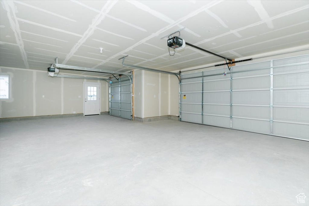 Garage featuring a garage door opener