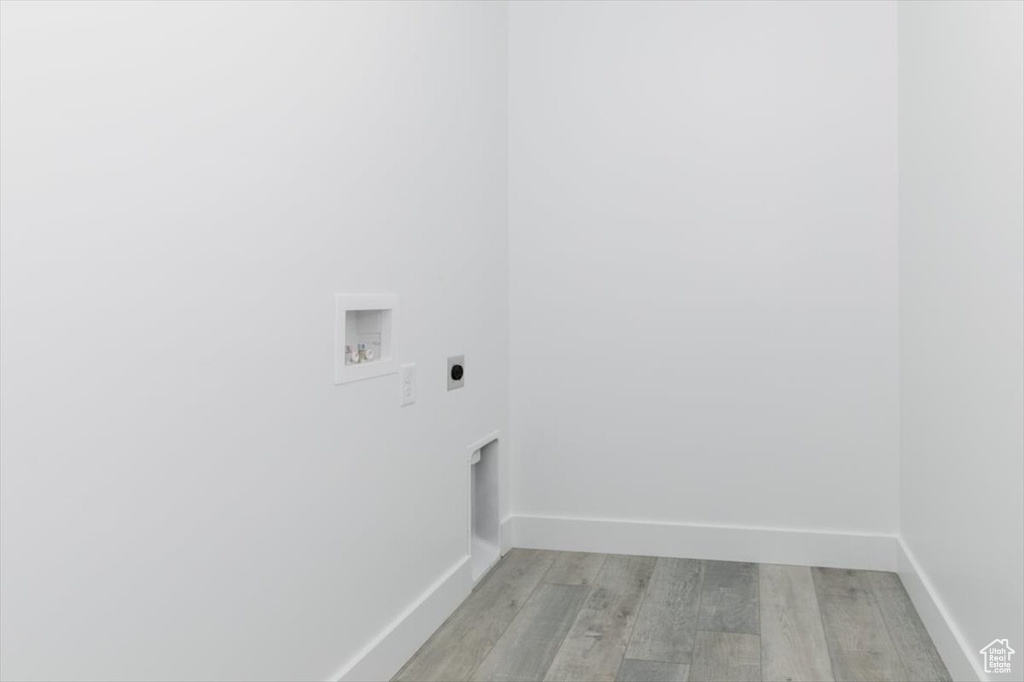 Washroom featuring light hardwood / wood-style floors, electric dryer hookup, and hookup for a washing machine