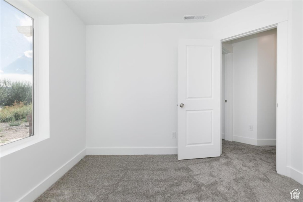 Empty room with light colored carpet