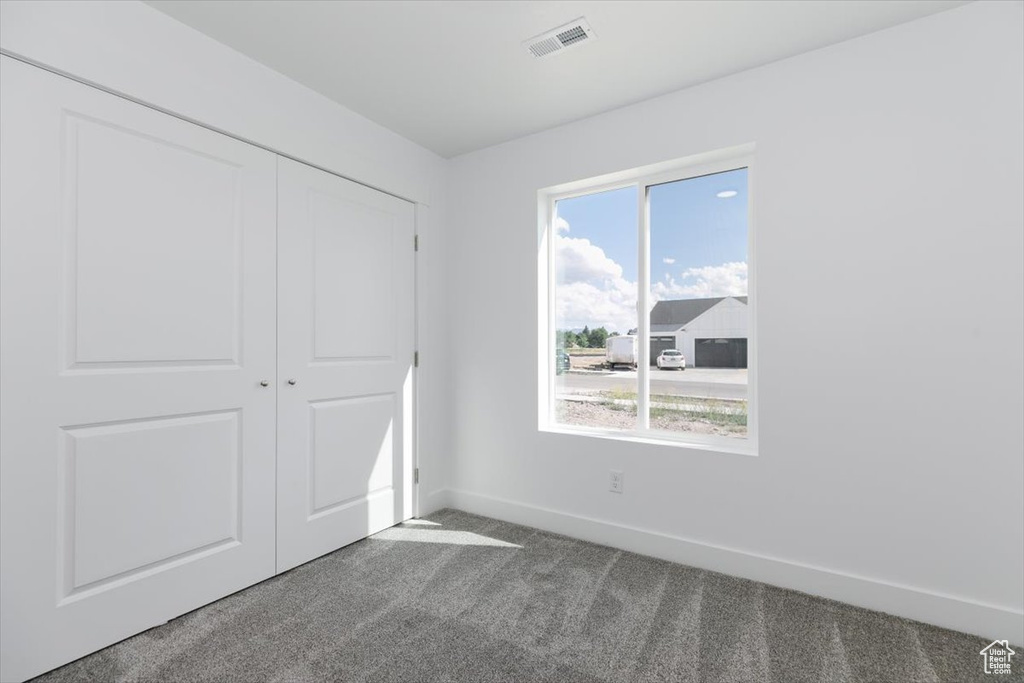 Unfurnished bedroom with carpet floors and a closet