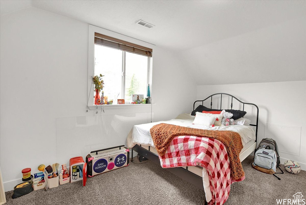 Bedroom featuring vaulted ceiling and carpet floors