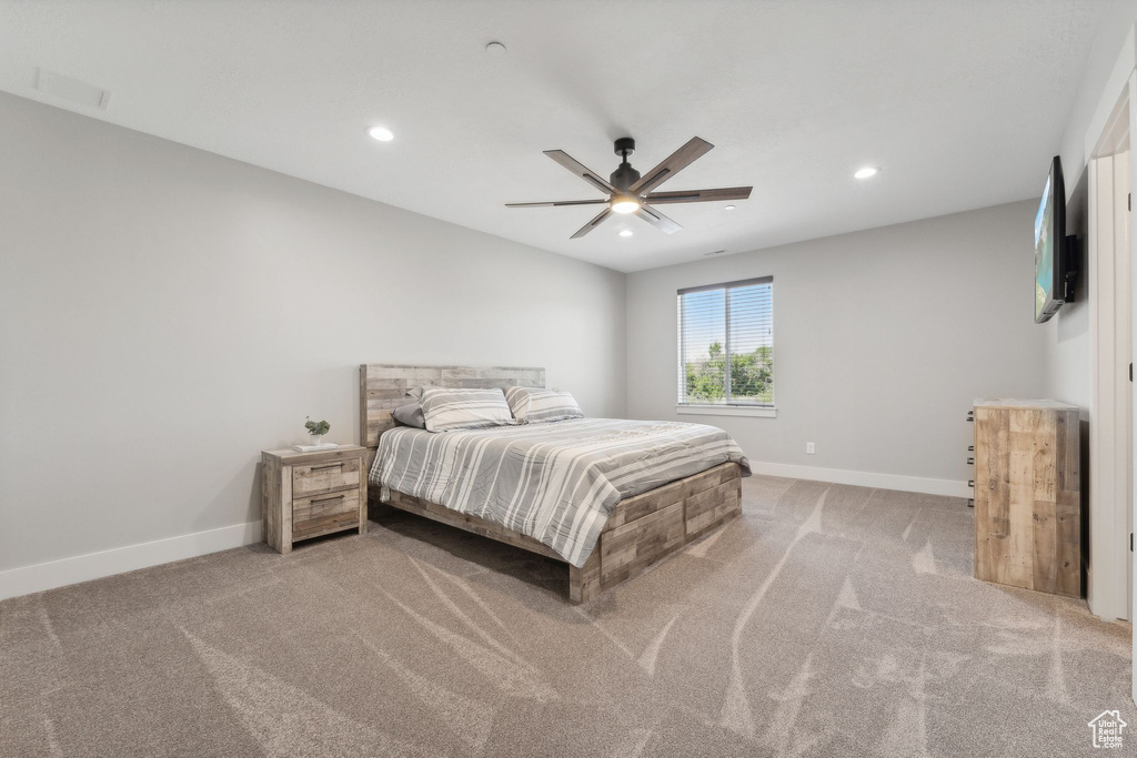 Carpeted bedroom with ceiling fan