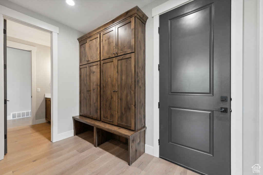 Mudroom with light hardwood / wood-style flooring