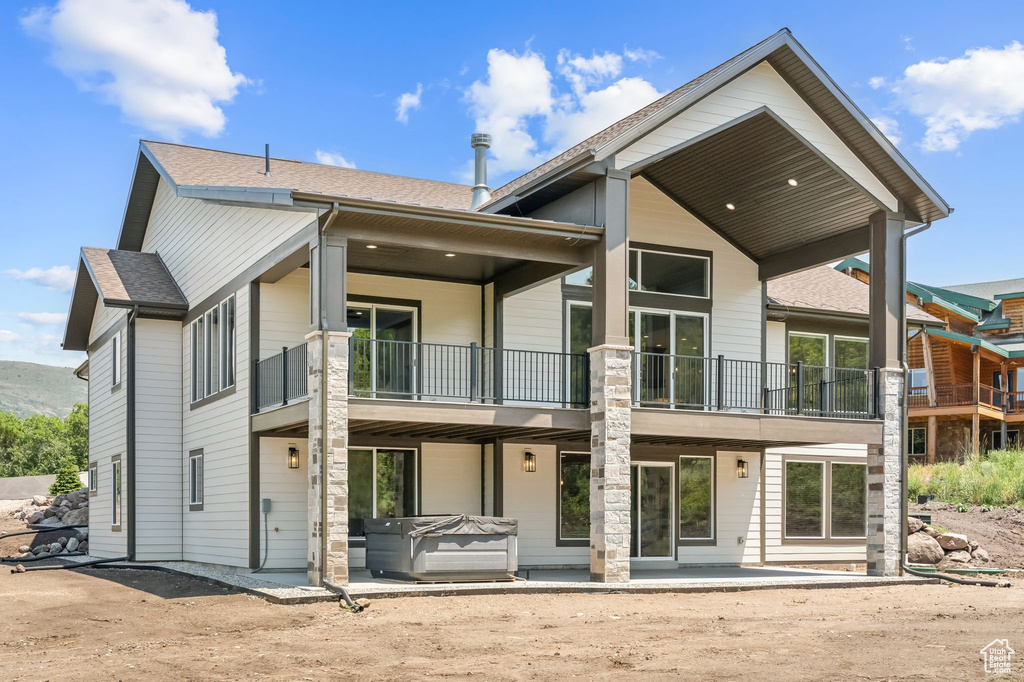 Back of house with a balcony