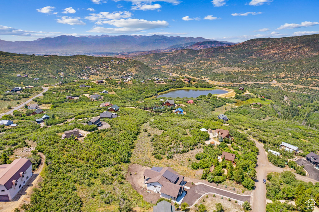 Drone / aerial view featuring a water and mountain view