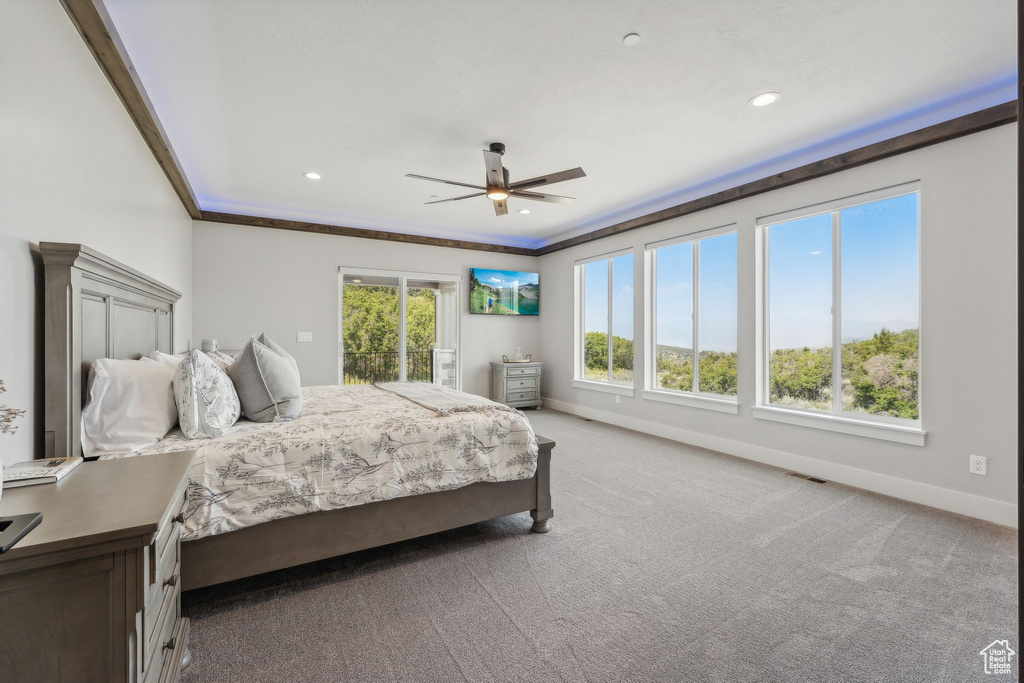 Carpeted bedroom featuring crown molding and ceiling fan