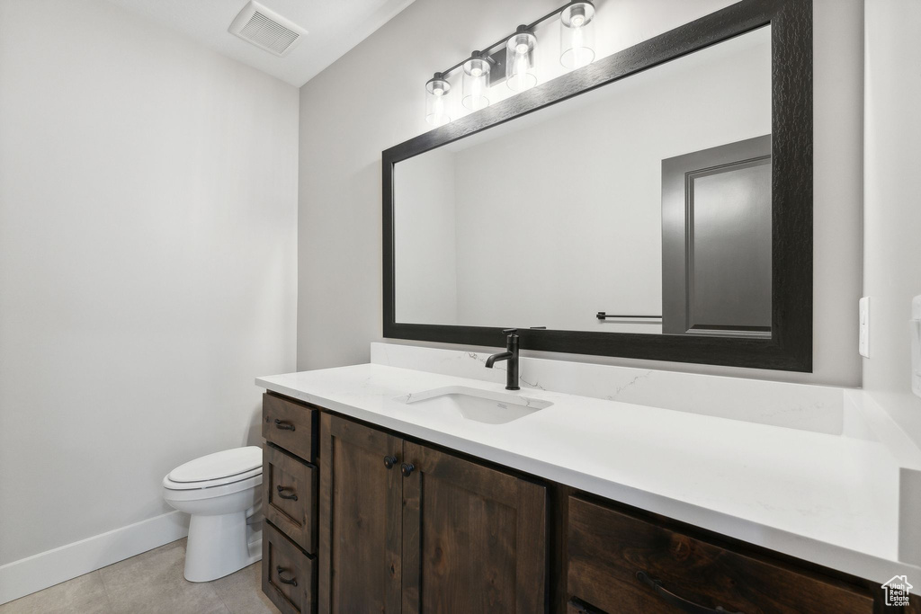 Bathroom with tile patterned floors, toilet, and vanity