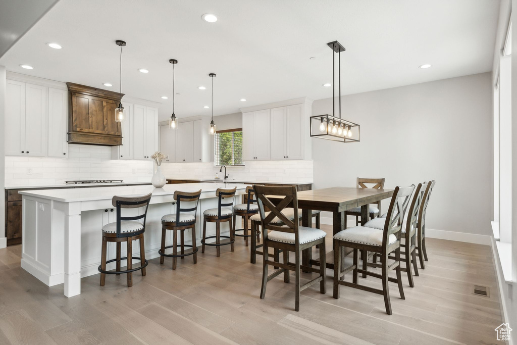 Dining space with sink and light hardwood / wood-style flooring