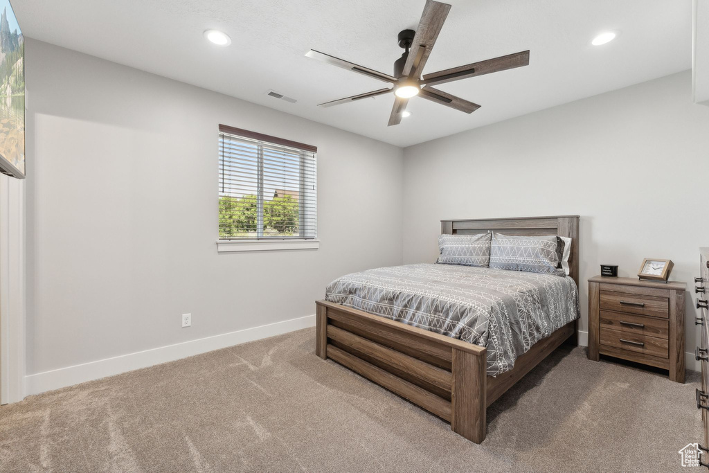 Carpeted bedroom with ceiling fan