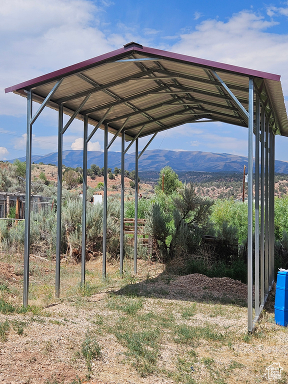 View of yard with a mountain view and a carport