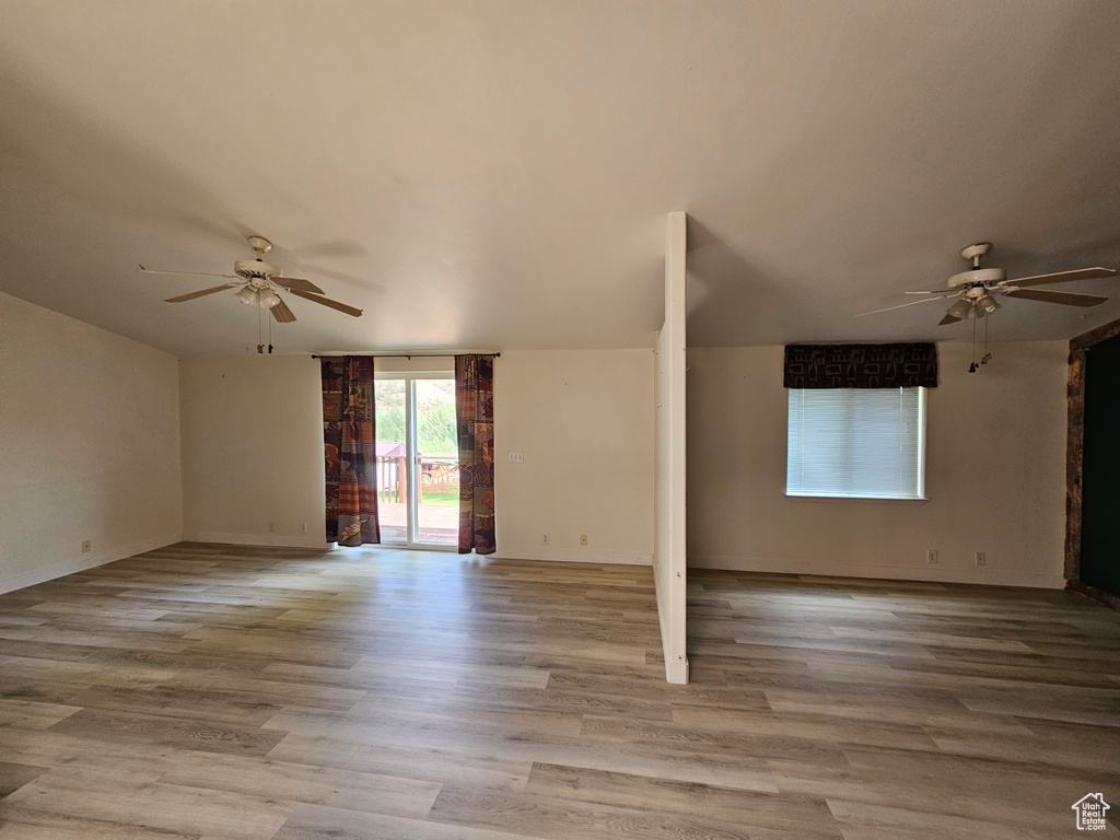 Empty room featuring ceiling fan and light wood-type flooring