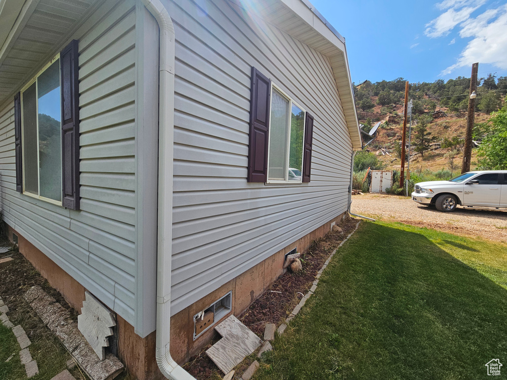 View of side of property featuring a yard