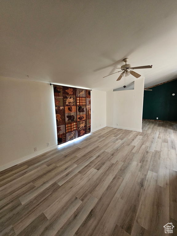 Unfurnished living room with ceiling fan and hardwood / wood-style floors