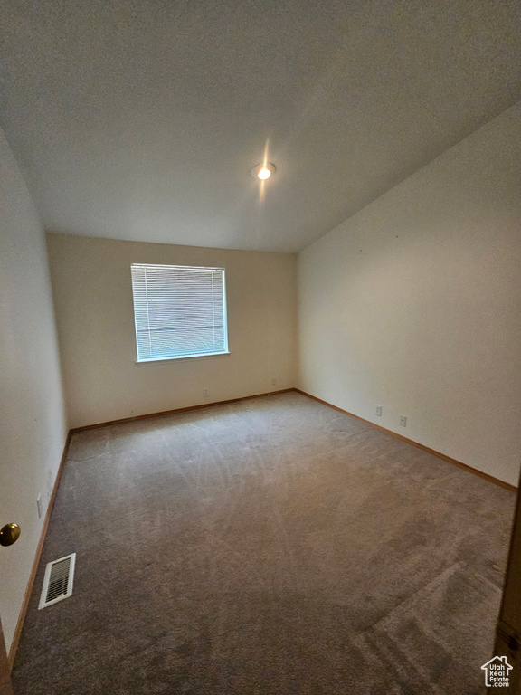 Spare room featuring carpet floors and a textured ceiling