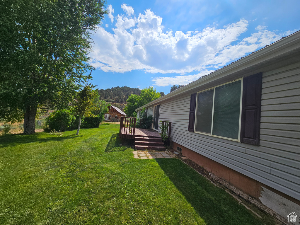 View of yard with a wooden deck