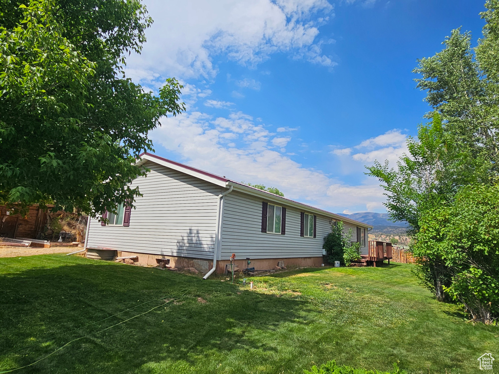 Rear view of property with a yard