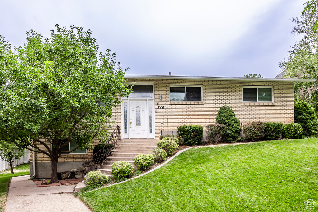 View of front of property with a front yard