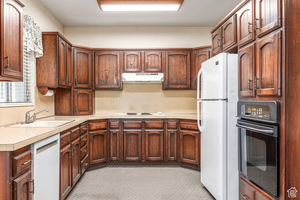 Kitchen with white appliances and sink