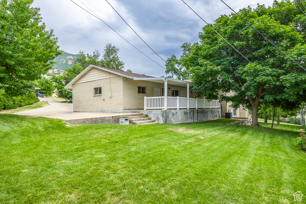 Rear view of property with a yard