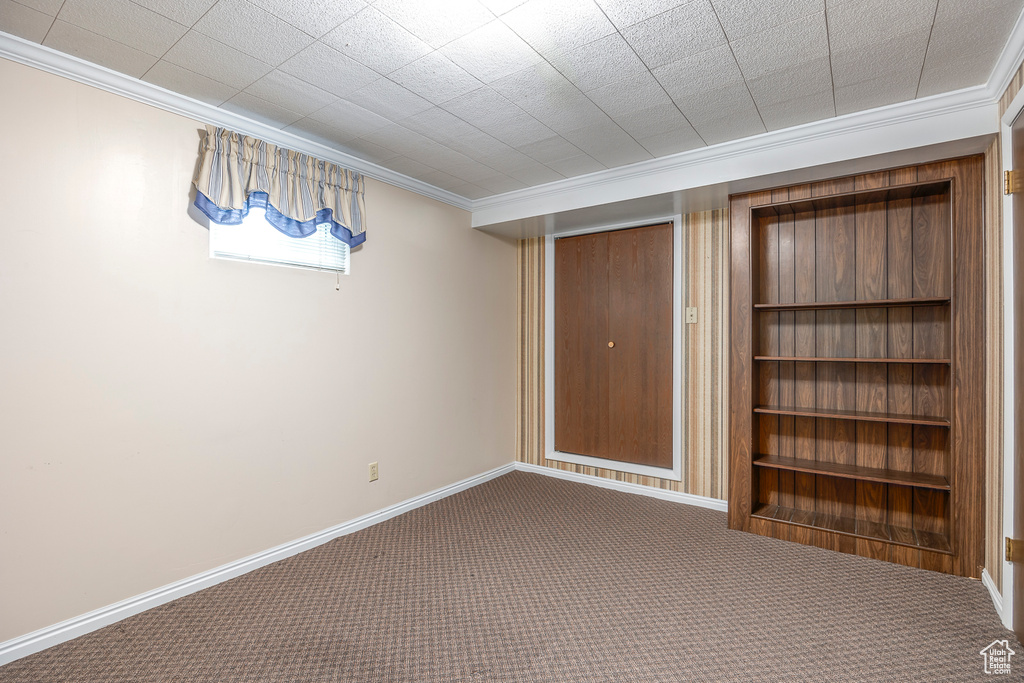 Carpeted empty room with ornamental molding