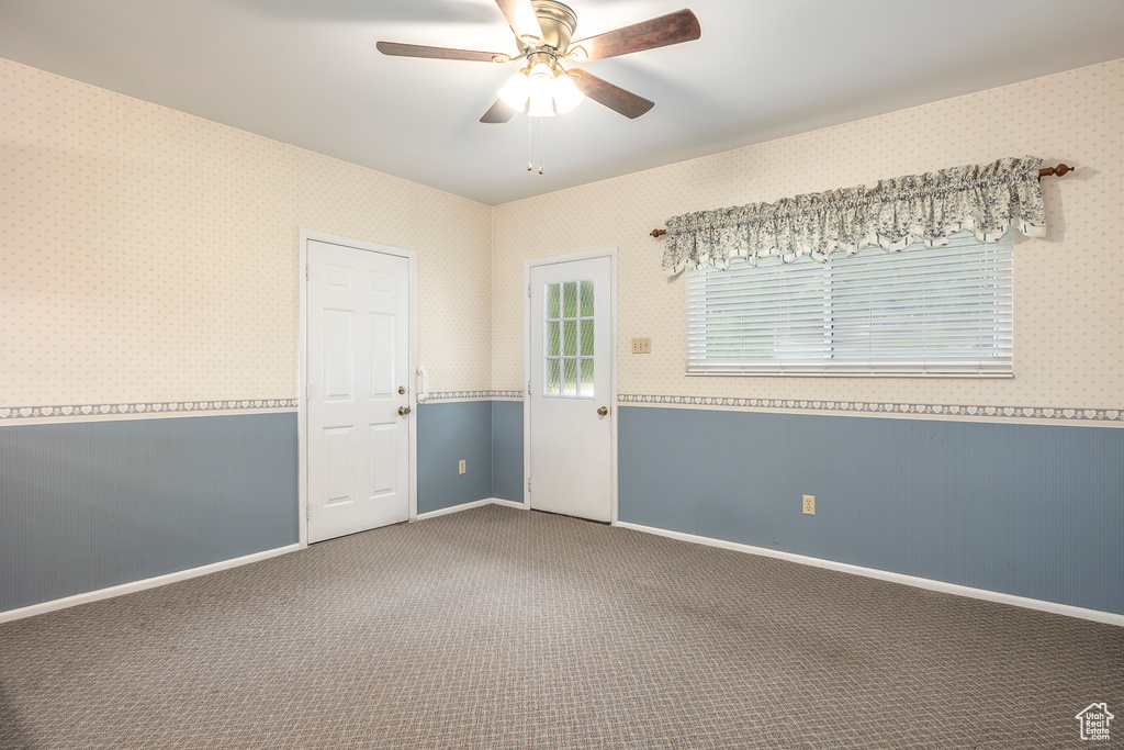 Unfurnished room featuring carpet flooring and ceiling fan