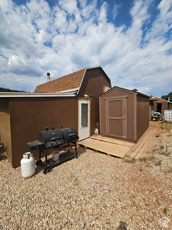 Back of house with a shed