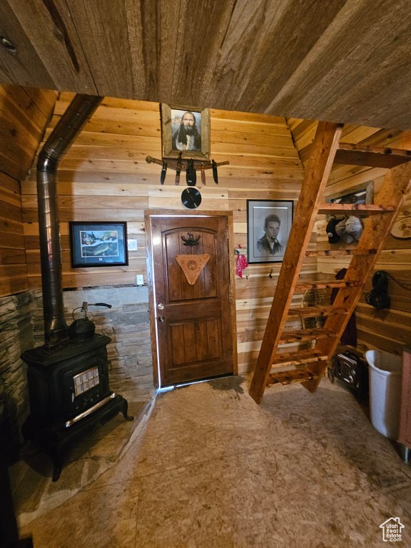 Foyer entrance with wood walls and a wood stove