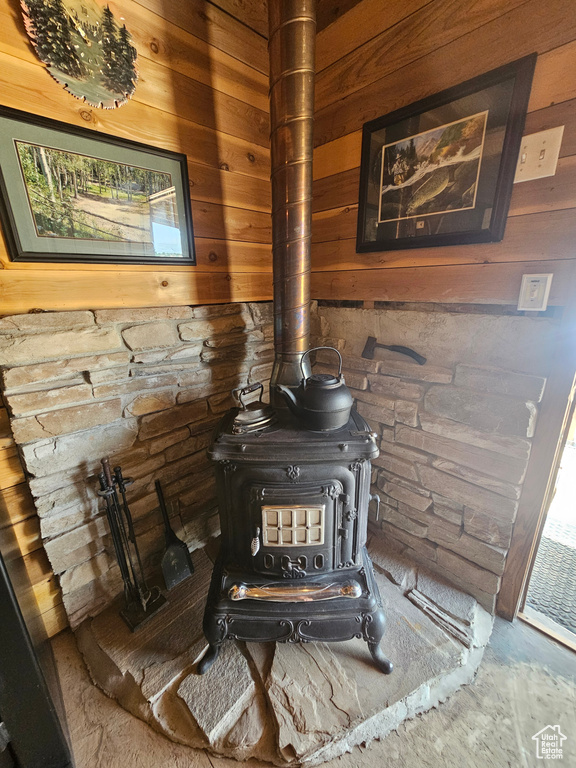 Interior details featuring wood walls and a wood stove