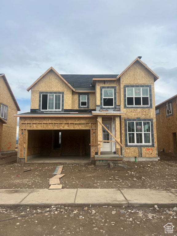 View of front of house featuring covered porch and a garage