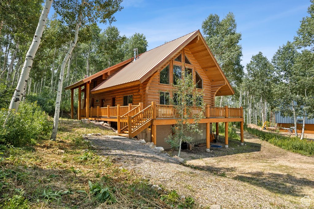 View of front of property featuring a wooden deck