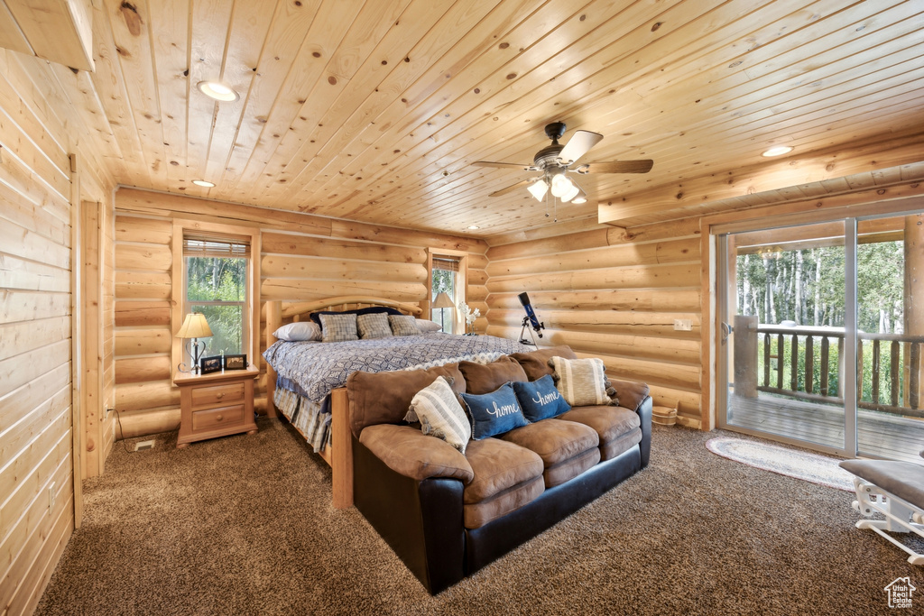 Bedroom featuring carpet flooring, rustic walls, and wooden ceiling