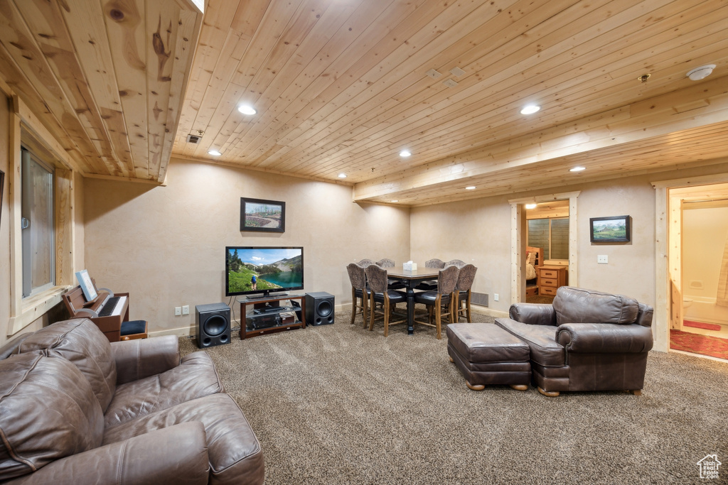 Living room featuring wooden ceiling and carpet flooring