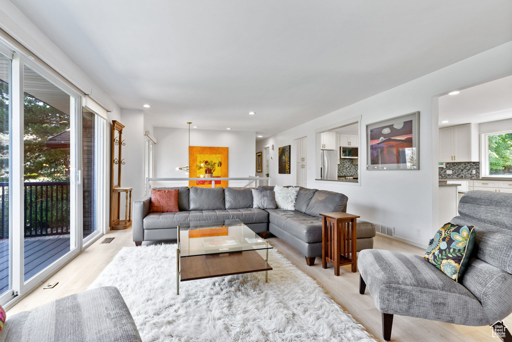 Living room with light hardwood / wood-style floors