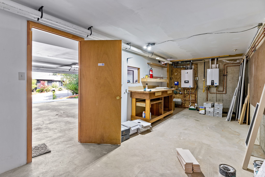 Basement featuring a workshop area and tankless water heater