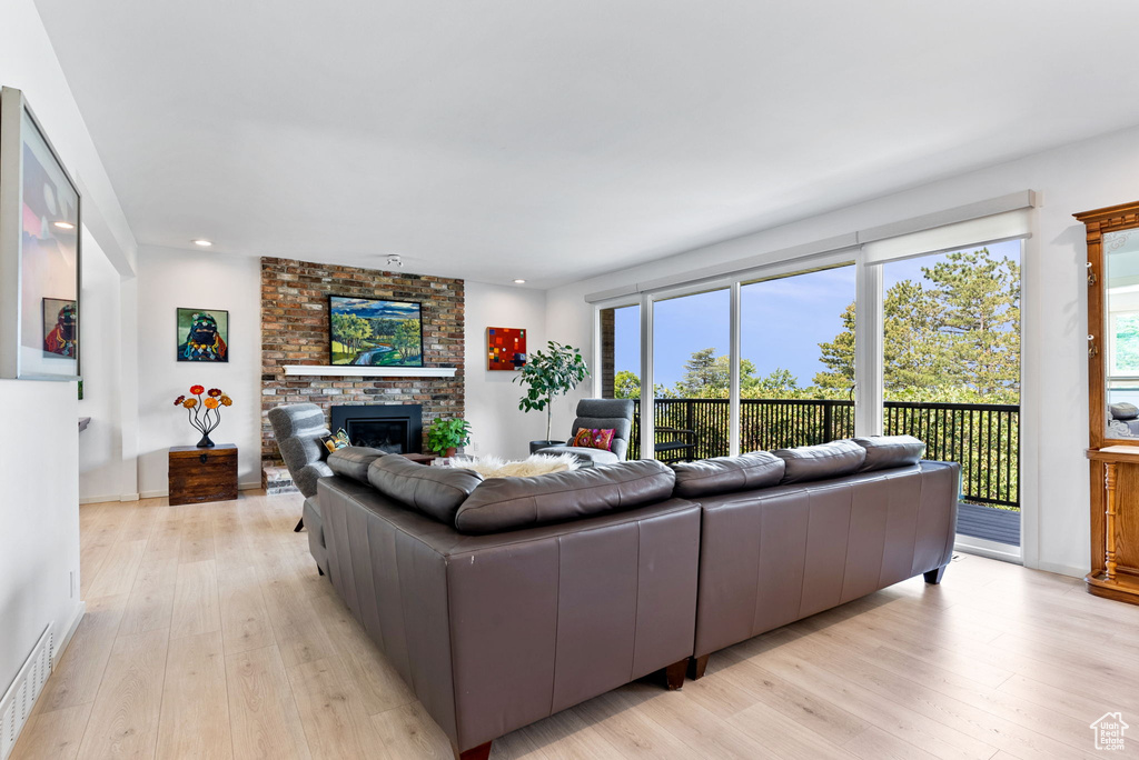 Living room featuring a fireplace and light hardwood / wood-style flooring