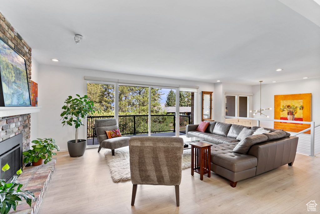 Living room featuring light hardwood / wood-style flooring and a brick fireplace