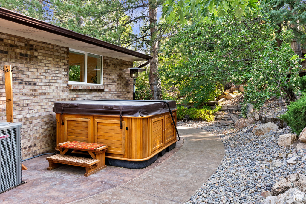 View of patio featuring central AC unit and a hot tub