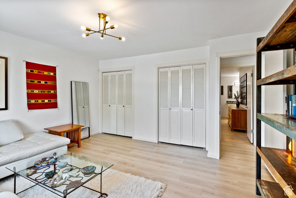 Living room featuring a chandelier and light wood-type flooring