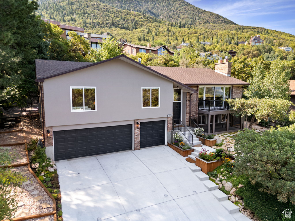 View of front facade with a mountain view and a garage