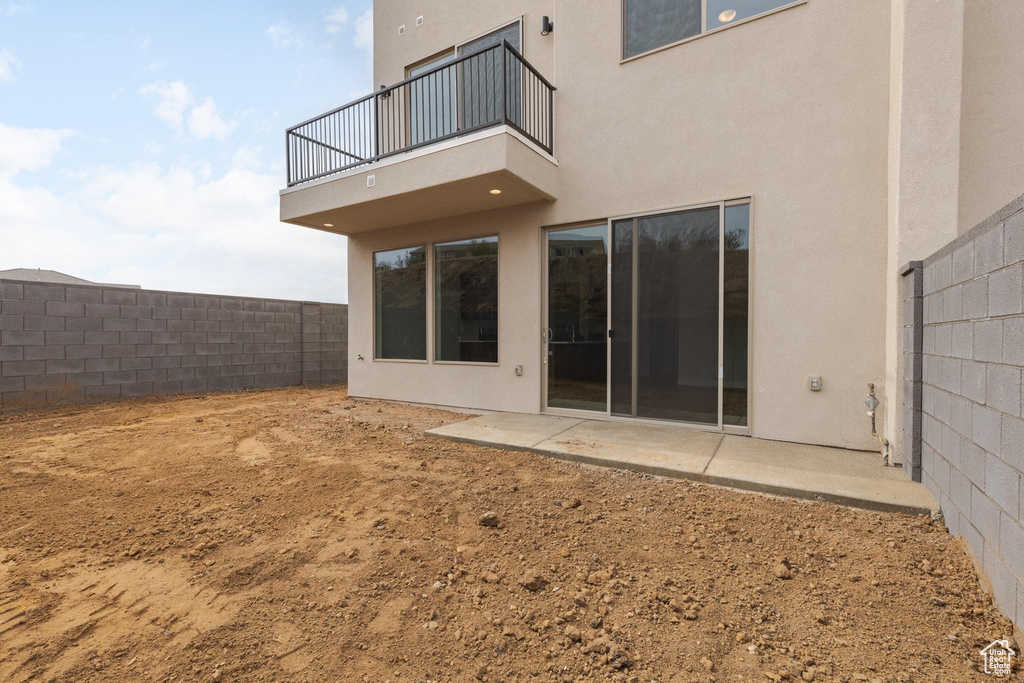 Rear view of property with a patio and a balcony