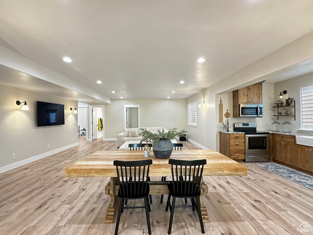 Dining area with light hardwood / wood-style floors and a wealth of natural light