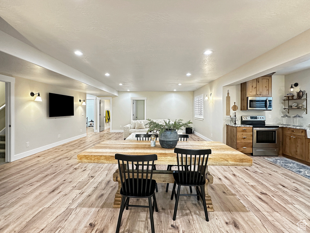 Dining room with light hardwood / wood-style flooring