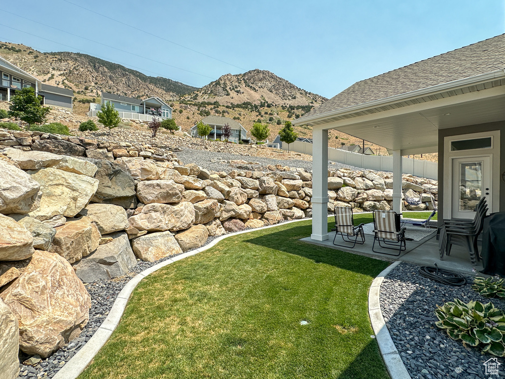 View of yard with a mountain view and a patio area