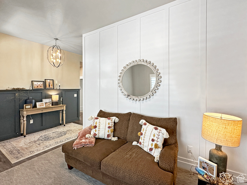 Carpeted living room with a chandelier