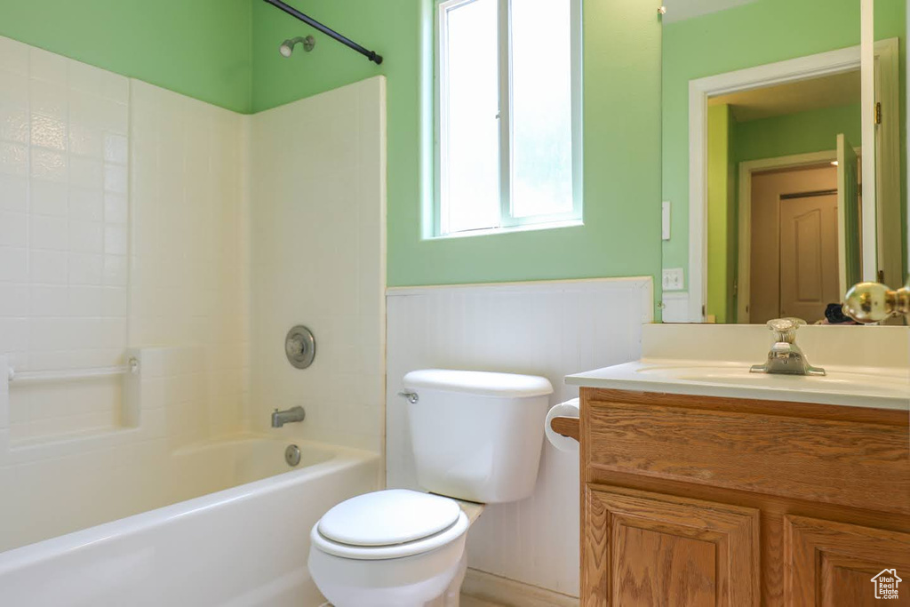 Full bathroom featuring vanity, bathtub / shower combination, and toilet