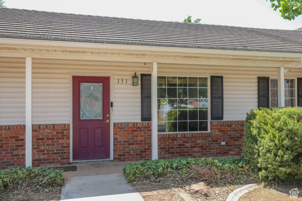 View of exterior entry with a porch