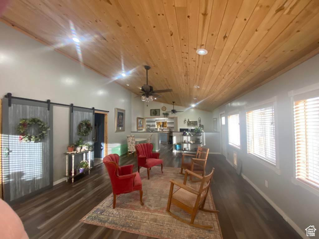 Living room with ceiling fan, plenty of natural light, and wood ceiling